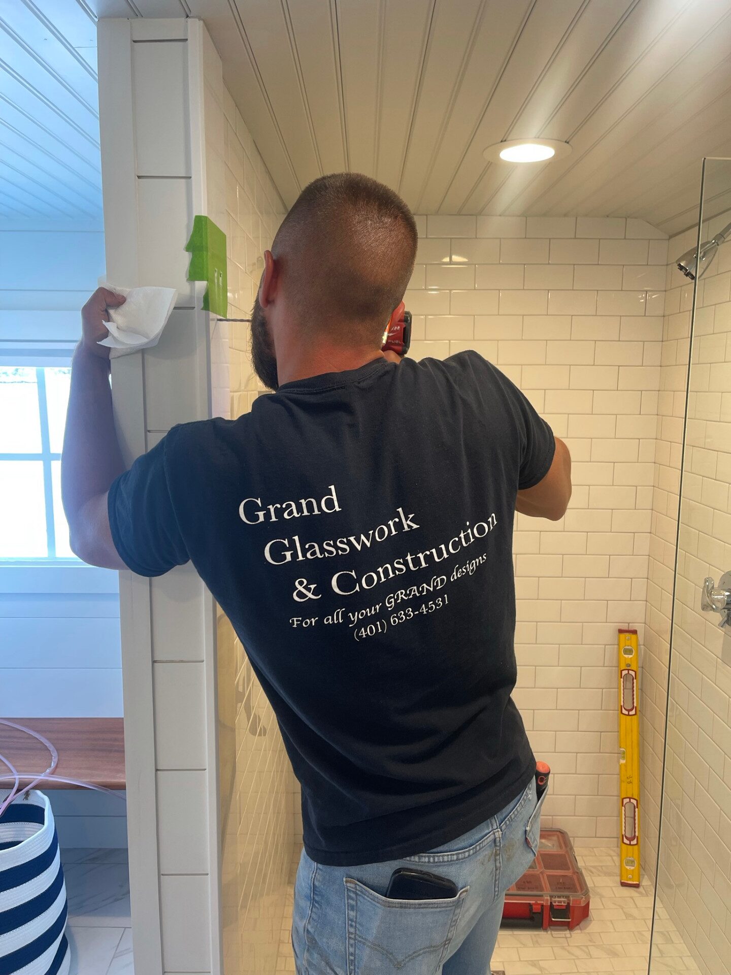 Grand Glasswork & Construction technician installing custom glass in a Rhode Island home