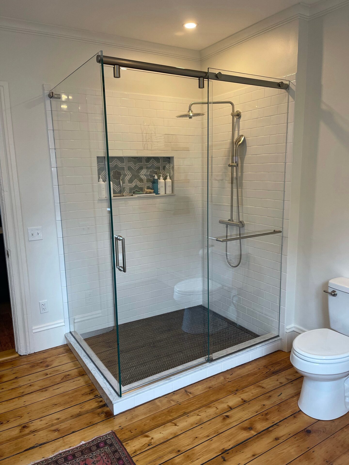 Custom frameless glass shower enclosure by Grand Glasswork & Construction in Rhode Island