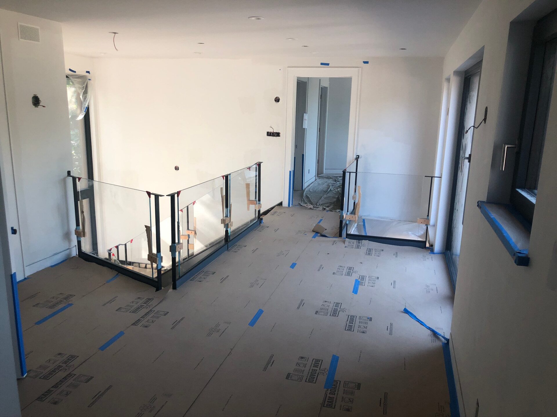 Modern glass railing system on an open loft balcony