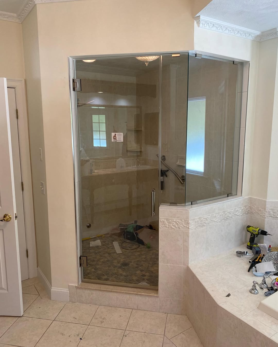 Custom corner glass shower enclosure paired with grey tile